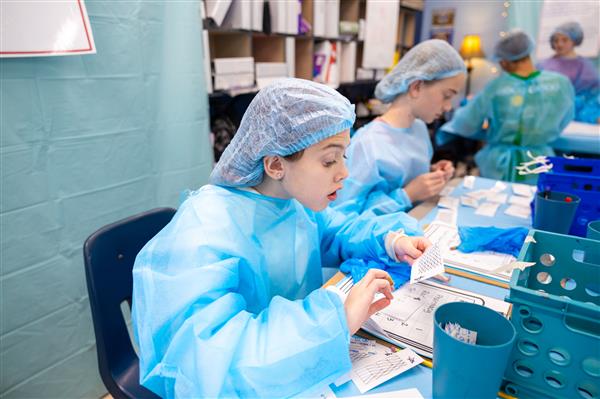 students in scrubs working at tables